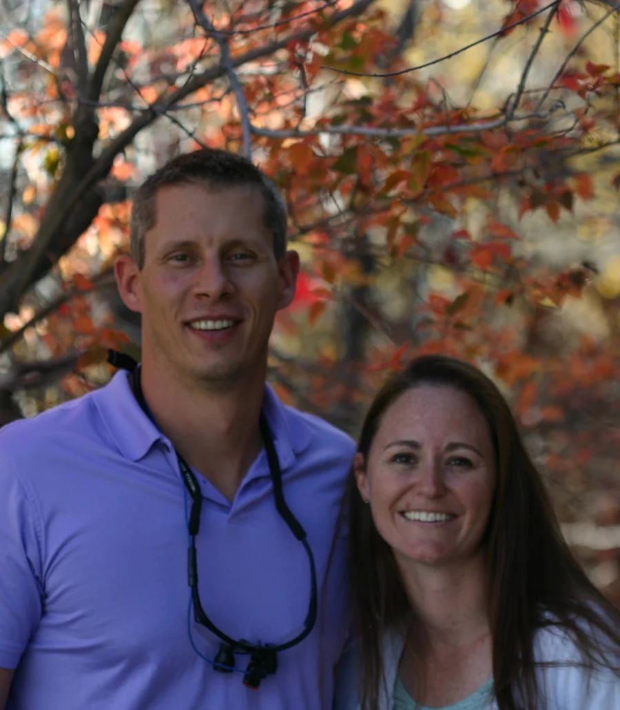 Dr. Brad Kincheloe and Dr. Erica Tonso side by side under an autumn tree.